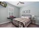 Bedroom with a metal frame bed, a piano keyboard, and a ceiling fan at 3037 Riders Pass, Odessa, FL 33556