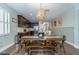 Light and bright dining area featuring farmhouse style table and accent lighting at 3037 Riders Pass, Odessa, FL 33556