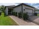 Well-maintained home exterior with manicured landscaping and a gated walkway at 3037 Riders Pass, Odessa, FL 33556