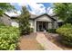 Charming single-story home with a welcoming front porch with seating and lush landscaping at 3037 Riders Pass, Odessa, FL 33556