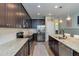 Well-equipped kitchen featuring granite countertops, stainless appliances, and dark wood cabinets at 3037 Riders Pass, Odessa, FL 33556