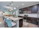 Modern kitchen with an island, pendant lighting, stainless steel appliances, and ample cabinet space at 3037 Riders Pass, Odessa, FL 33556