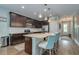 Gourmet kitchen with granite countertops, island seating, stainless appliances, and ample storage at 3037 Riders Pass, Odessa, FL 33556