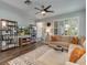 Open-concept living room with a sectional sofa, decorative shelving, and natural light at 3037 Riders Pass, Odessa, FL 33556