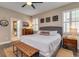 Comfortable main bedroom with decoratively adorned wall and ensuite bathroom access at 3037 Riders Pass, Odessa, FL 33556