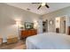 Bright and airy main bedroom featuring a flatscreen television and ensuite bathroom at 3037 Riders Pass, Odessa, FL 33556