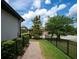 Side yard featuring manicured landscaping and brick walkway at 3037 Riders Pass, Odessa, FL 33556
