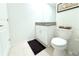 Cozy half-bathroom showcasing a toilet, vanity with granite top, and decorative accents at 30798 Veridian Way, Wesley Chapel, FL 33543