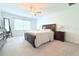 Primary bedroom with neutral carpet, ceiling fan, and large window at 30798 Veridian Way, Wesley Chapel, FL 33543