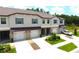 Charming townhouses boast a brown roof, neutral facade, and neat landscaping, creating curb appeal at 30798 Veridian Way, Wesley Chapel, FL 33543