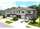 Inviting townhouse exteriors featuring attached garages, blue shutters, manicured lawns, and a pristine driveway at 30798 Veridian Way, Wesley Chapel, FL 33543