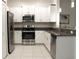 Modern kitchen with stainless steel appliances, granite countertops, and white cabinetry at 30798 Veridian Way, Wesley Chapel, FL 33543