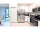 The kitchen showcases stainless steel appliances, plenty of cabinet space, and tiled floors at 30798 Veridian Way, Wesley Chapel, FL 33543