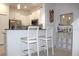 Stylish kitchen with white cabinetry, granite counters, stainless steel appliances and a modern breakfast bar at 30798 Veridian Way, Wesley Chapel, FL 33543