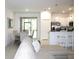 Open-concept living area with dining table, stainless steel appliances and a large sliding glass door at 30798 Veridian Way, Wesley Chapel, FL 33543