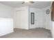 Spacious upper level loft area featuring neutral carpet, fan, and plenty of natural light at 30798 Veridian Way, Wesley Chapel, FL 33543