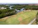 Aerial view of a golf course, mangroves and boats docked in the community's waterfront access at 3200 Cove Cay Dr # 5F, Clearwater, FL 33760