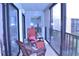 Relaxing enclosed balcony with comfortable seating, perfect for enjoying the views at 3200 Cove Cay Dr # 5F, Clearwater, FL 33760