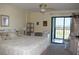 Bright bedroom with ceiling fan and access to balcony with views at 3200 Cove Cay Dr # 5F, Clearwater, FL 33760