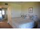Bright bedroom with a comfortable bed and view to a balcony at 3200 Cove Cay Dr # 5F, Clearwater, FL 33760