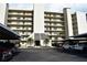 Exterior view of a multi-story building with covered parking and well-maintained landscaping at 3200 Cove Cay Dr # 5F, Clearwater, FL 33760