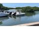 Boats and jet skis sit docked in the community, surrounded by lush green trees and sparkling blue water at 3200 Cove Cay Dr # 5F, Clearwater, FL 33760