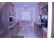 Well-lit kitchen featuring wood cabinets, stainless steel appliances, and a cozy breakfast nook at 3200 Cove Cay Dr # 5F, Clearwater, FL 33760
