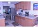 Bright kitchen with stainless steel appliances, wood cabinets, and a double sink at 3200 Cove Cay Dr # 5F, Clearwater, FL 33760