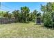 Expansive backyard with lush greenery, a privacy fence and a small shed or storage area at 3317 15Th N St, St Petersburg, FL 33704