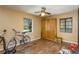 Simple bedroom with hardwood floors, a ceiling fan, and natural light from two windows at 3317 15Th N St, St Petersburg, FL 33704