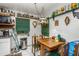 Dining area featuring a vintage light fixture, a small table, and adjacent storage shelves at 3317 15Th N St, St Petersburg, FL 33704