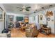 Cozy living room with wood flooring, a ceiling fan, and ample natural light at 3317 15Th N St, St Petersburg, FL 33704