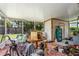 Enclosed sunroom with outdoor access; needs cleaning and decluttering at 3317 15Th N St, St Petersburg, FL 33704