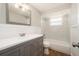 Light filled bathroom featuring a shower and a bright, neutral color scheme with a large vanity mirror at 3509 Brookston Dr, Holiday, FL 34691