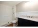 Bright bathroom featuring a walk-in shower, modern vanity with a stylish countertop, and updated fixtures at 3509 Brookston Dr, Holiday, FL 34691