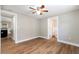 Inviting bedroom with wood floors, light gray walls, and easy access to the kitchen and bathroom at 3509 Brookston Dr, Holiday, FL 34691