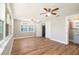 Bright bedroom with wood-look floors and ceiling fans, complemented by natural light and a modern design at 3509 Brookston Dr, Holiday, FL 34691