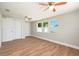 Spacious bedroom with wood-look flooring, natural light, and ceiling fans for added comfort and style at 3509 Brookston Dr, Holiday, FL 34691