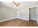 The neutral bedroom boasts stylish, wood-look floors, and a bright ceiling fan fixture at 3509 Brookston Dr, Holiday, FL 34691