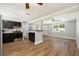 Updated kitchen with stainless appliances, dark cabinetry, and views into the adjacent living area at 3509 Brookston Dr, Holiday, FL 34691