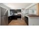 Modern kitchen features stainless steel appliances, dark cabinets, and stylish countertops at 3509 Brookston Dr, Holiday, FL 34691