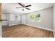Bright living room featuring hardwood floors, fresh paint and a ceiling fan, perfect for entertaining at 3509 Brookston Dr, Holiday, FL 34691