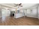 Spacious living area with hardwood floors, and views into the updated kitchen at 3509 Brookston Dr, Holiday, FL 34691