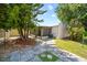 Landscaped backyard featuring a patio and access to the screened patio at 4326 Fern Glen St, Holiday, FL 34691
