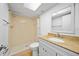 Bright bathroom featuring a walk-in shower, modern vanity, and a skylight at 4326 Fern Glen St, Holiday, FL 34691