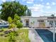 Charming single-story home with lush landscaping and a covered parking area at 4326 Fern Glen St, Holiday, FL 34691