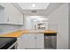 View of kitchen with butcher block countertops and stainless steel appliances, open to other living areas at 4326 Fern Glen St, Holiday, FL 34691