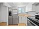 Modern kitchen with stainless steel appliances and bright white cabinets at 4326 Fern Glen St, Holiday, FL 34691