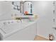 Functional laundry area featuring washer, dryer, and water heater in a clean, well-lit space at 4326 Fern Glen St, Holiday, FL 34691