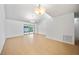 Large living room with neutral tile flooring and sliding glass door to screened patio at 4326 Fern Glen St, Holiday, FL 34691